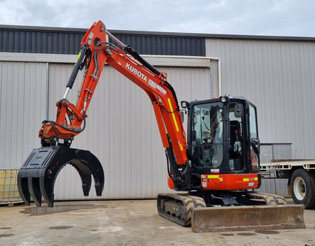 This image features an Impact brand five-finger grab attachment mounted on an excavator, designed for heavy-duty material handling tasks in construction and demolition projects. The close-up view highlights the grab's durable construction, making it ideal for efficiently sorting, lifting, and moving various materials, including debris, timber, and scrap metal. This attachment enhances the excavator's versatility and productivity in challenging work environments.