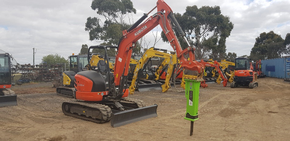 Kubota U55-4 excavator with Impact Attachments hydraulic breaker attachment, ready for heavy-duty demolition tasks at a construction equipment yard