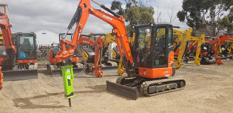 Kubota U35-4 mini excavator equipped with an Impact Attachments hydraulic breaker, ideal for demolition and excavation tasks on construction sites.