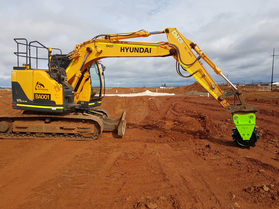 Hyundai excavator equipped with an Impact Compaction Plate attachment, designed for efficient soil and ground compaction on construction sites, ensuring a stable and level surface for building and infrastructure projects