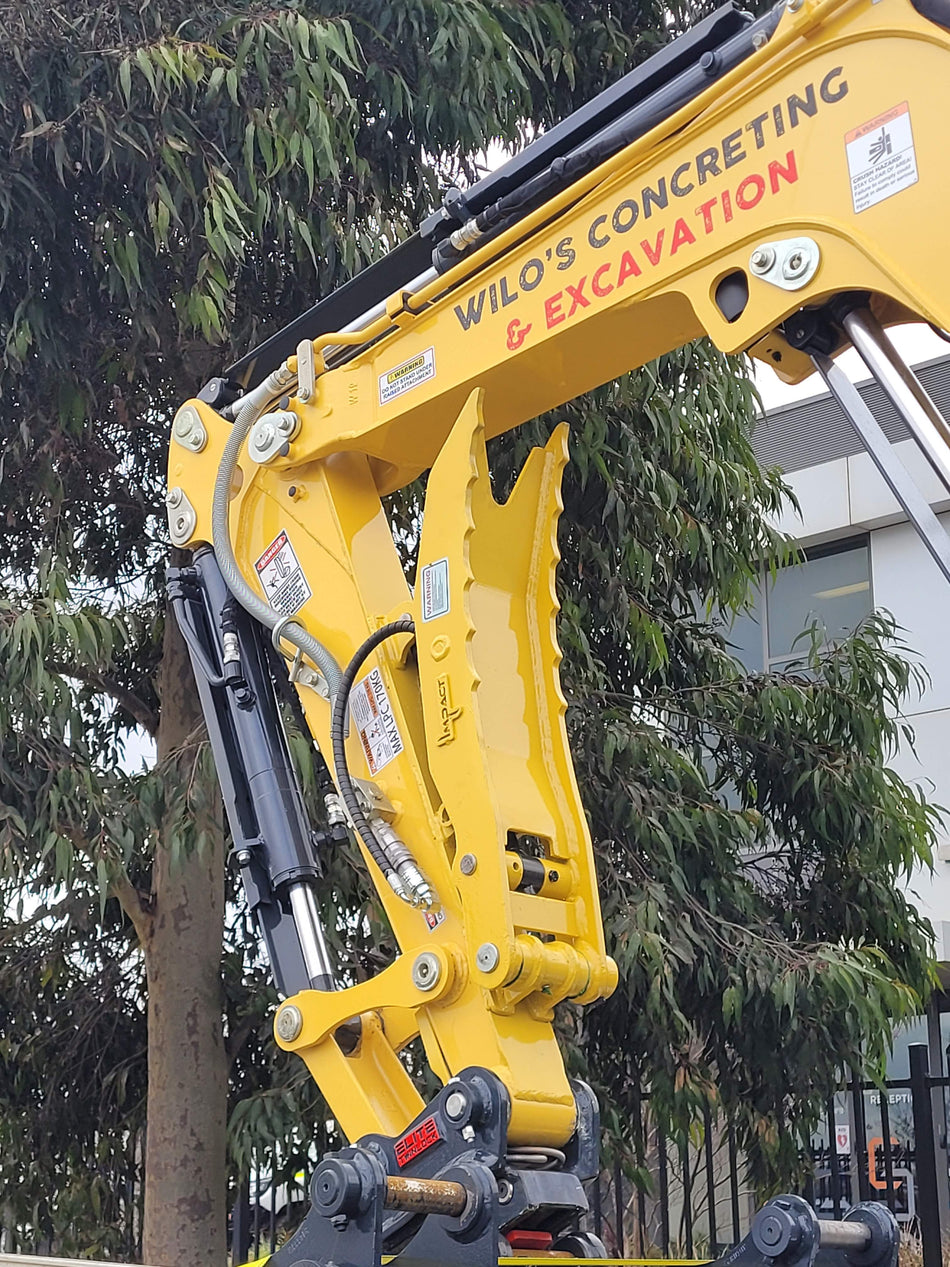 Wilo’s Concreting & Excavation truck carrying a 3-tonne excavator, showcasing professional concrete services including driveways, paving, exposed aggregate, and shed slabs, with contact details prominently displayed.
