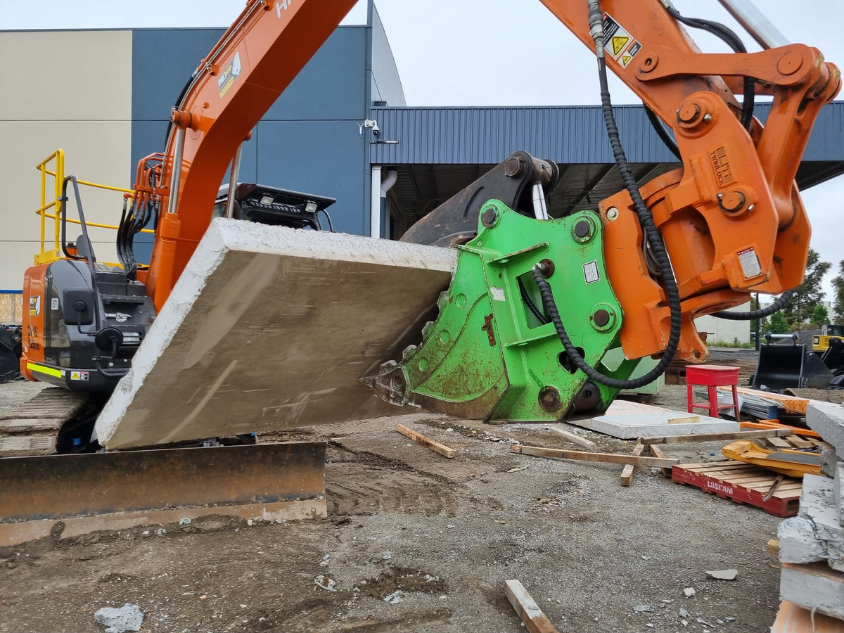 Impact brand heavy-duty grapple bucket attachment mounted on a Volvo excavator, designed for efficient material handling, demolition, and clearing tasks. The robust construction and powerful gripping capability of this grapple bucket make it ideal for various construction, forestry, and recycling applications, enhancing operational productivity and precision."