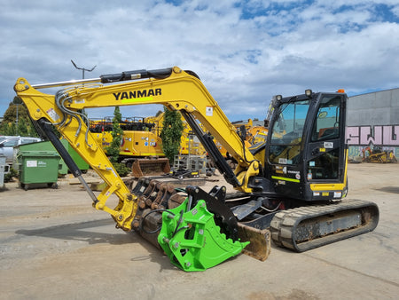 Yanmar mini excavator equipped with an Impact Attachments grapple bucket, ideal for material handling and demolition work on a construction site