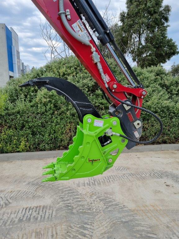 Impact brand heavy-duty grapple bucket attachment mounted on a Volvo excavator, designed for efficient material handling, demolition, and clearing tasks. The robust construction and powerful gripping capability of this grapple bucket make it ideal for various construction, forestry, and recycling applications, enhancing operational productivity and precision