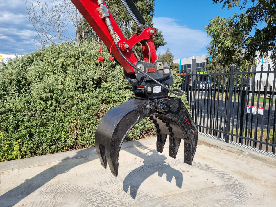 This image features an Impact brand five-finger grab attachment mounted on an excavator, designed for heavy-duty material handling tasks in construction and demolition projects. The close-up view highlights the grab's durable construction, making it ideal for efficiently sorting, lifting, and moving various materials, including debris, timber, and scrap metal. This attachment enhances the excavator's versatility and productivity in challenging work environments.