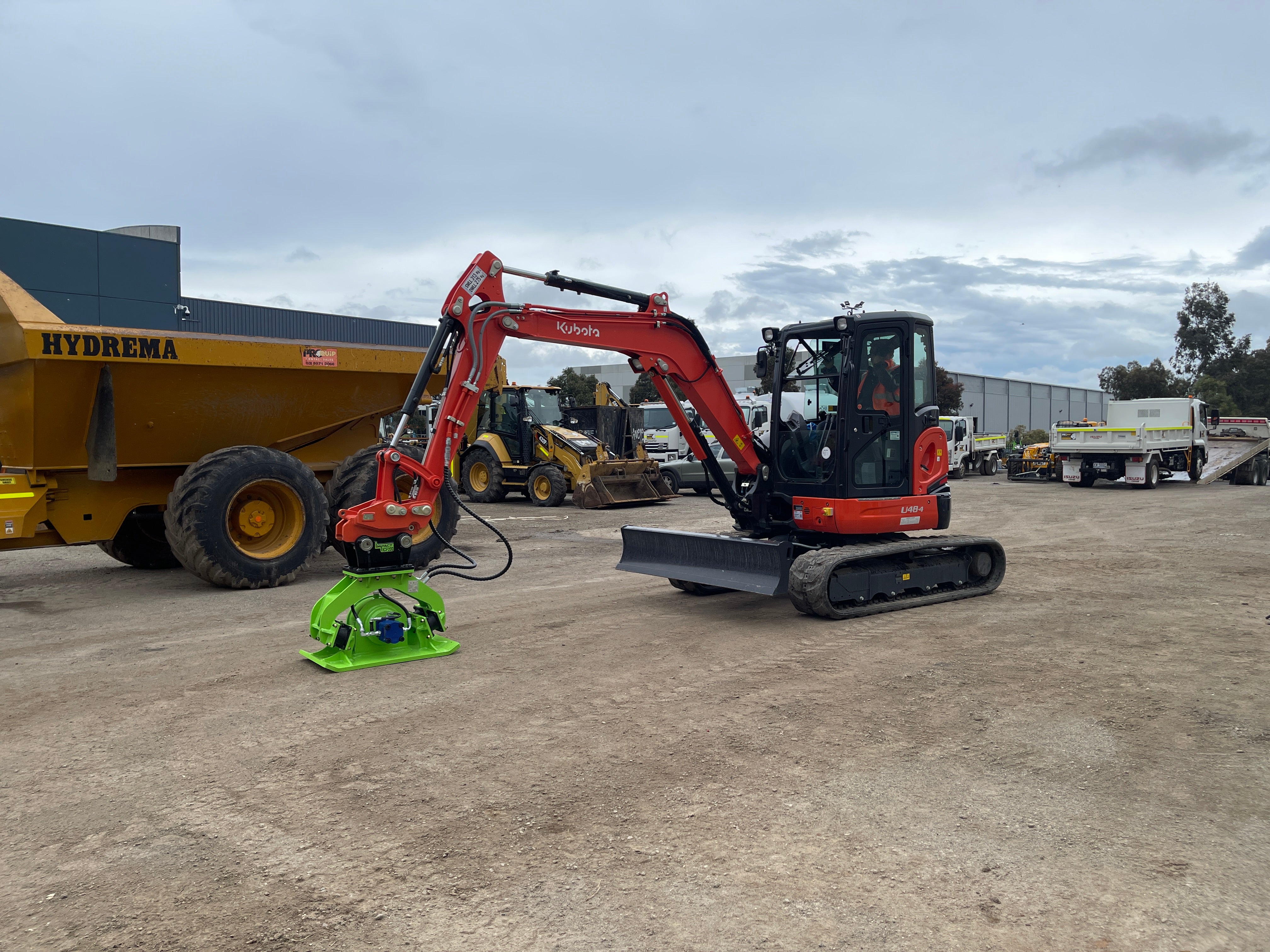Kubota mini excavator equipped with an Impact hydraulic compaction plate, designed for efficient soil compaction on construction sites. This combination enhances productivity in earthmoving and site preparation tasks, ensuring reliable performance in compact and confined spaces.