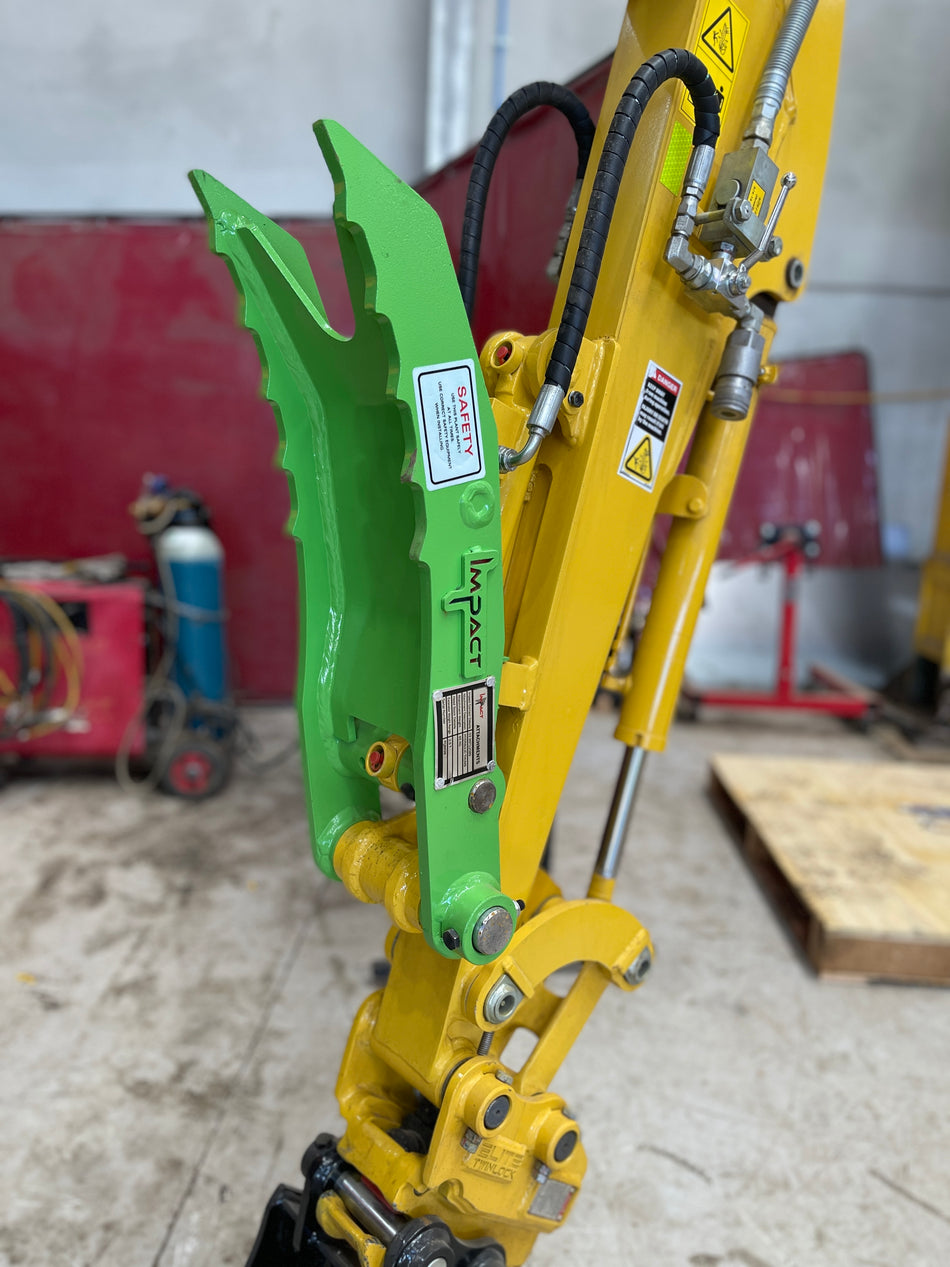 Yellow excavator equipped with an Impact hydraulic thumb attachment, designed for enhanced material handling and precision in excavation tasks, featuring high durability and easy installation