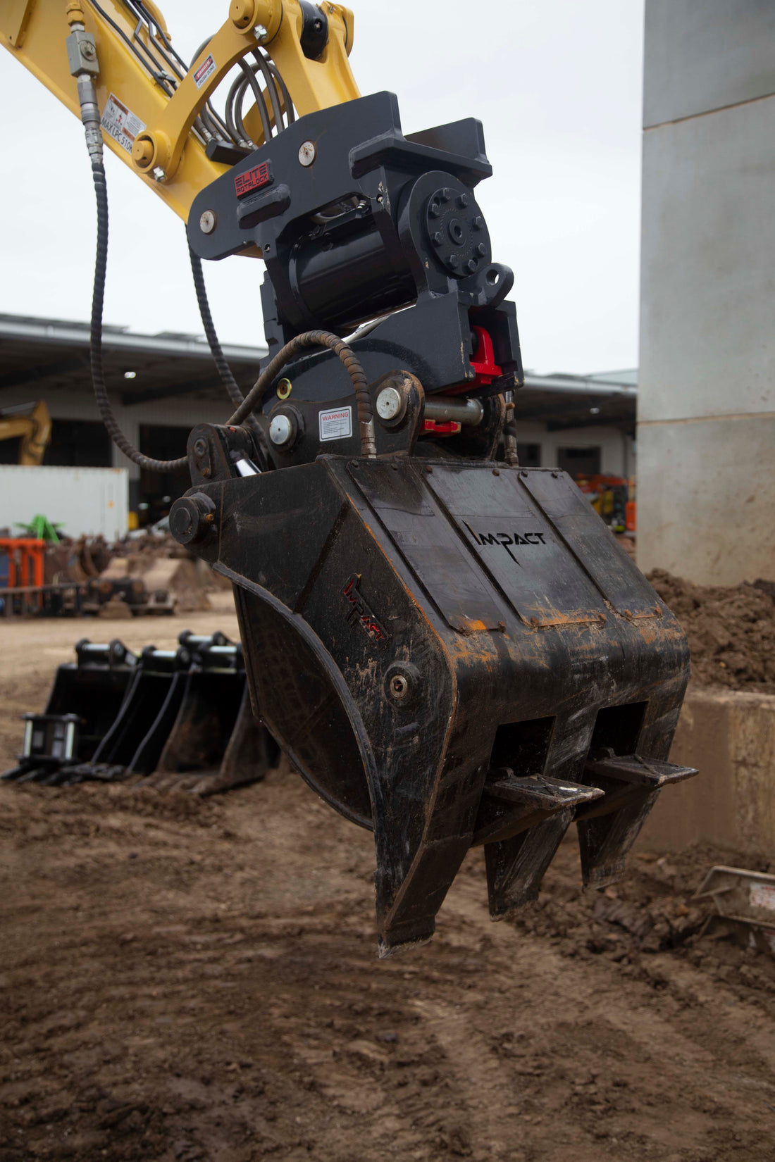 This image features an Impact brand five-finger grab attachment mounted on an excavator, designed for heavy-duty material handling tasks in construction and demolition projects. The close-up view highlights the grab's durable construction, making it ideal for efficiently sorting, lifting, and moving various materials, including debris, timber, and scrap metal. This attachment enhances the excavator's versatility and productivity in challenging work environments.