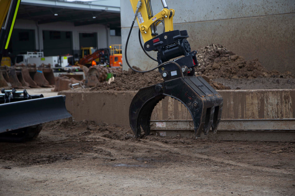 This image features an Impact brand five-finger grab attachment mounted on an excavator, designed for heavy-duty material handling tasks in construction and demolition projects. The close-up view highlights the grab's durable construction, making it ideal for efficiently sorting, lifting, and moving various materials, including debris, timber, and scrap metal. This attachment enhances the excavator's versatility and productivity in challenging work environments.