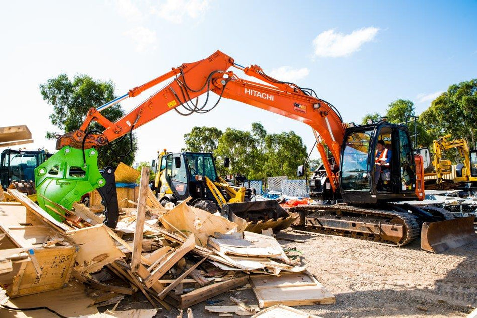 Impact brand heavy-duty grapple bucket attachment mounted on a Volvo excavator, designed for efficient material handling, demolition, and clearing tasks. The robust construction and powerful gripping capability of this grapple bucket make it ideal for various construction, forestry, and recycling applications, enhancing operational productivity and precision."