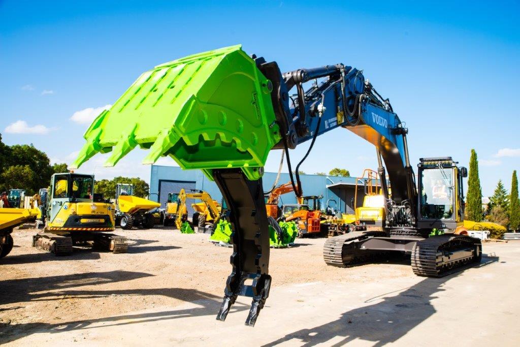 Impact brand heavy-duty grapple bucket attachment mounted on a Volvo excavator, designed for efficient material handling, demolition, and clearing tasks. The robust construction and powerful gripping capability of this grapple bucket make it ideal for various construction, forestry, and recycling applications, enhancing operational productivity and precision."