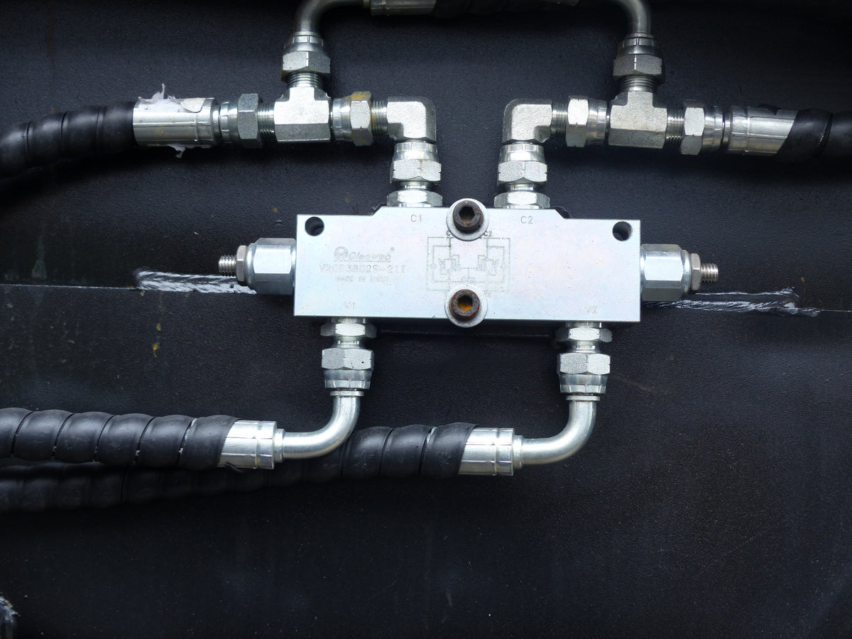 Close-up view of an Impact 4 in 1 bucket attachment on a track loader/skid steer, highlighting the heavy-duty construction and branding, ideal for various excavation and material handling tasks in construction