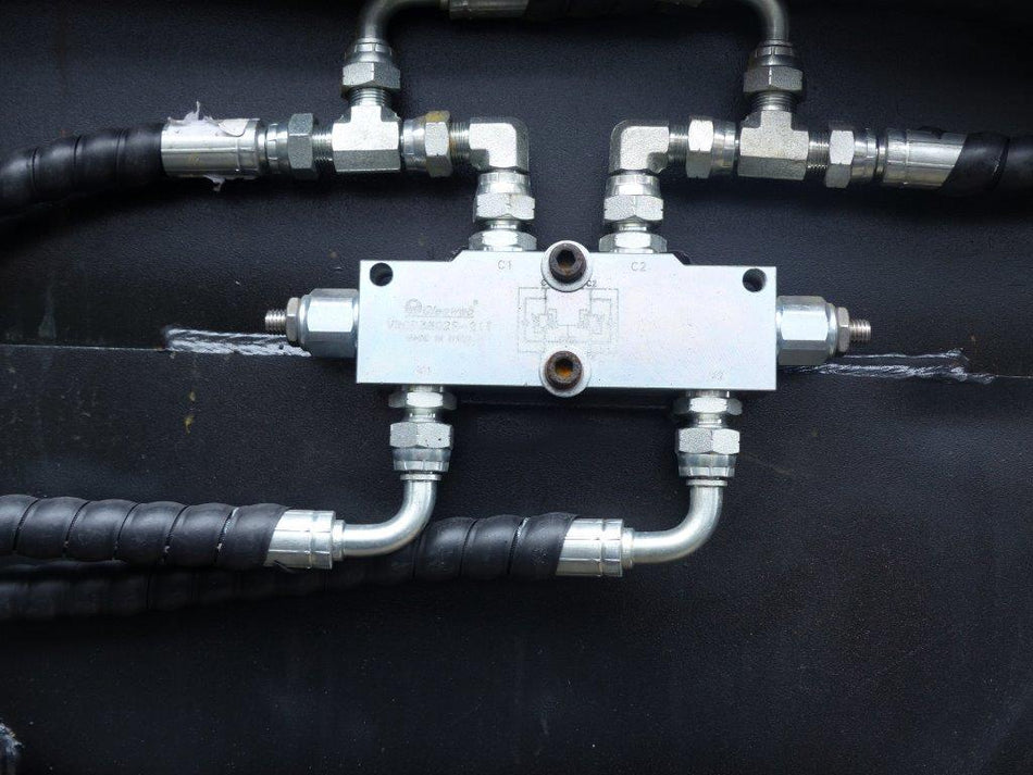 Close-up view of an Impact 4 in 1 bucket attachment on a track loader/skid steer, highlighting the heavy-duty construction and branding, ideal for various excavation and material handling tasks in construction.