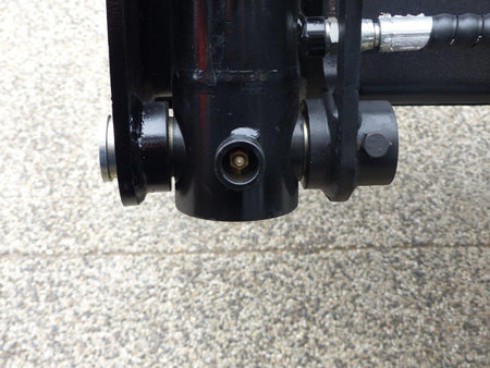 Close-up view of an Impact 4 in 1 bucket attachment on a track loader/skid steer, highlighting the heavy-duty construction and branding, ideal for various excavation and material handling tasks in construction