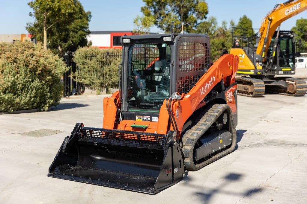 Kubota SVL75-2 track loader equipped with an Impact 4 in 1 bucket attachment, ideal for versatile excavation, material handling, and construction tasks.
