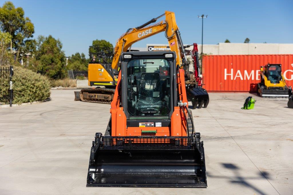 Kubota SVL75-2 track loader equipped with an Impact 4 in 1 bucket attachment, ideal for versatile excavation, material handling, and construction tasks