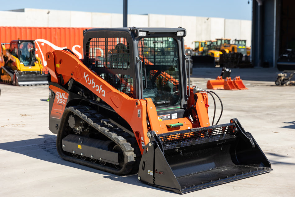 Kubota SVL75-2 track loader equipped with an Impact 4 in 1 bucket attachment, ideal for versatile excavation, material handling, and construction tasks.