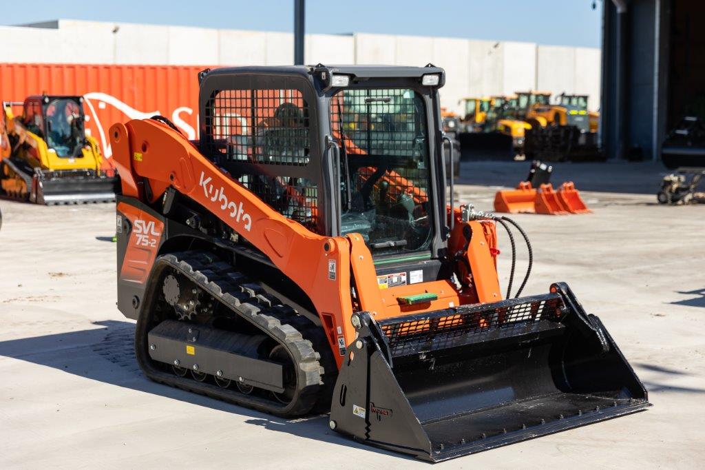 Kubota SVL75-2 track loader equipped with an Impact 4 in 1 bucket attachment, ideal for versatile excavation, material handling, and construction tasks.