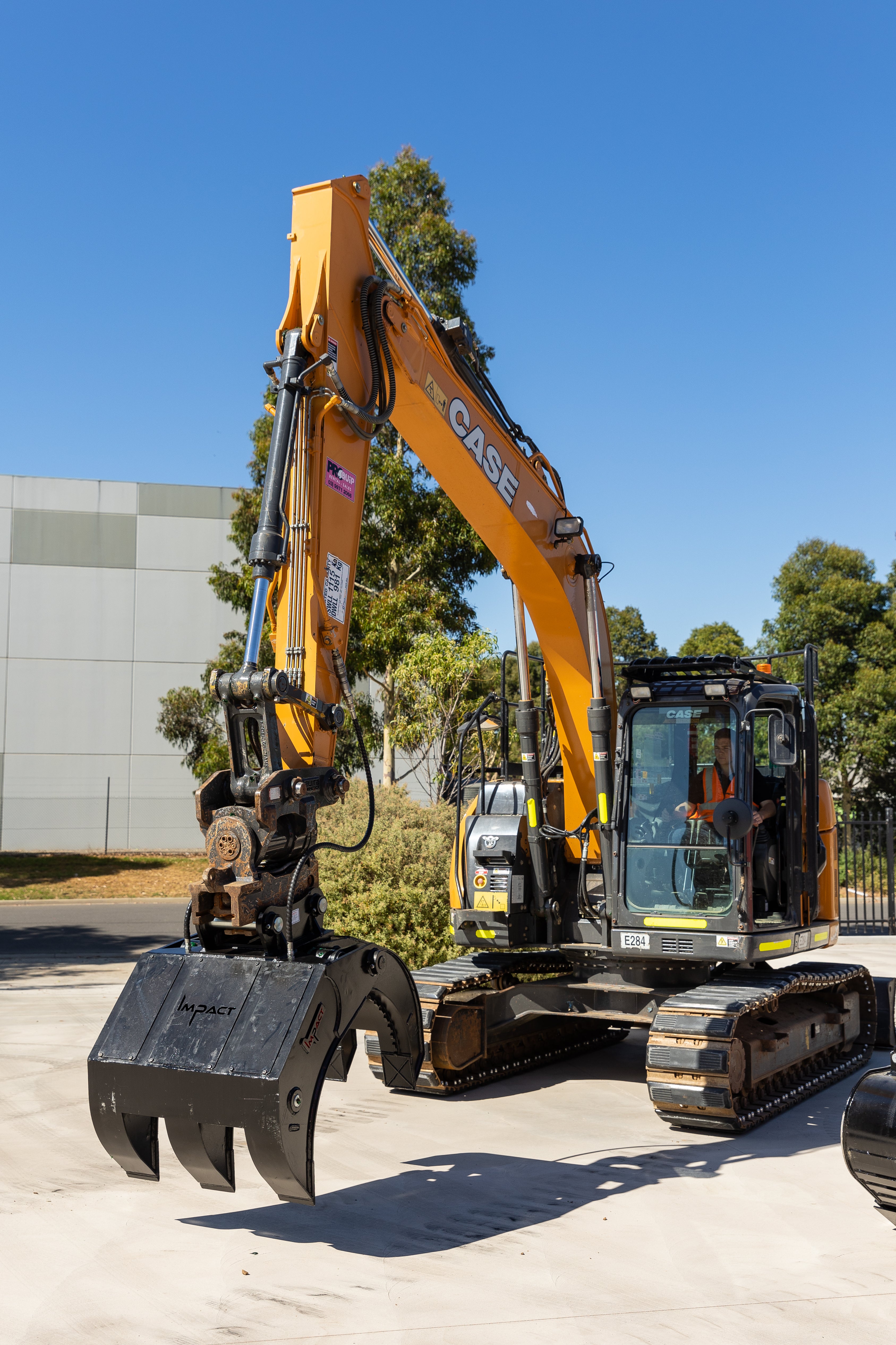 CASE excavator equipped with an Impact five finger grab, used for material handling and debris removal in construction and demolition projects. The heavy-duty grapple attachment enhances the excavator's versatility, making it ideal for demanding earthmoving tasks