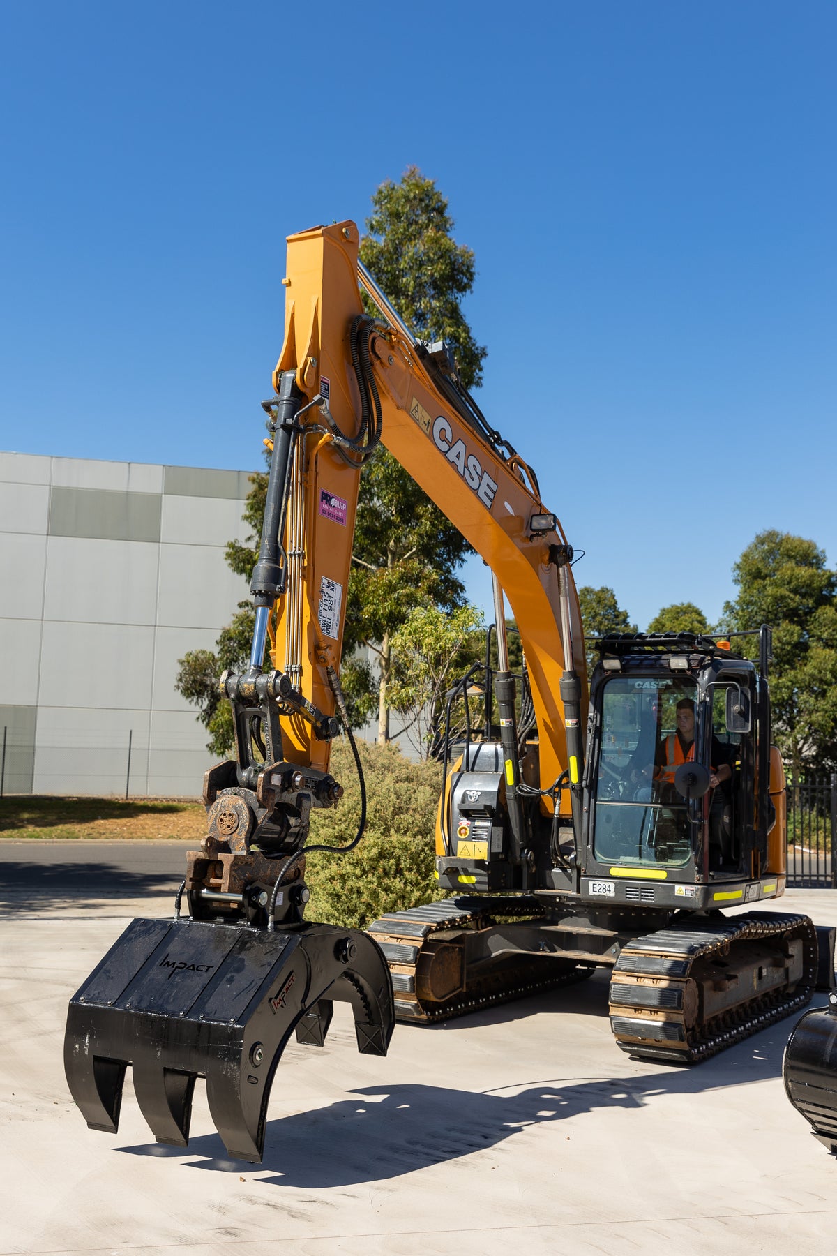 CASE excavator fitted with an Impact heavy-duty five finger grab, designed for efficient material handling, sorting, and debris removal in construction and demolition projects. The durable grapple attachment enhances versatility and productivity on-site.
