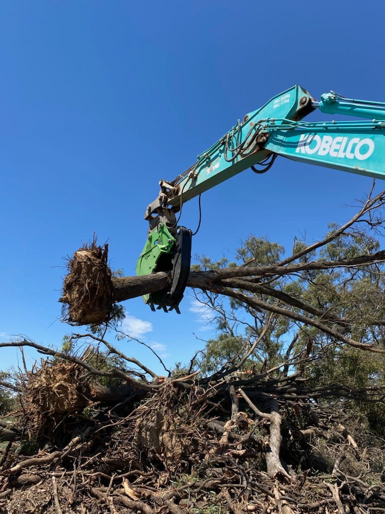Impact brand heavy-duty grapple bucket attachment mounted on a Volvo excavator, designed for efficient material handling, demolition, and clearing tasks. The robust construction and powerful gripping capability of this grapple bucket make it ideal for various construction, forestry, and recycling applications, enhancing operational productivity and precision."