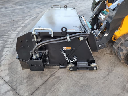 Impact Attachments hydraulic broom connected to a Hyundai skid steer, designed for efficient sweeping and debris removal on construction sites.